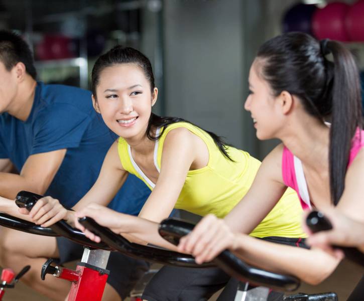 Group of young people spinning in the gym